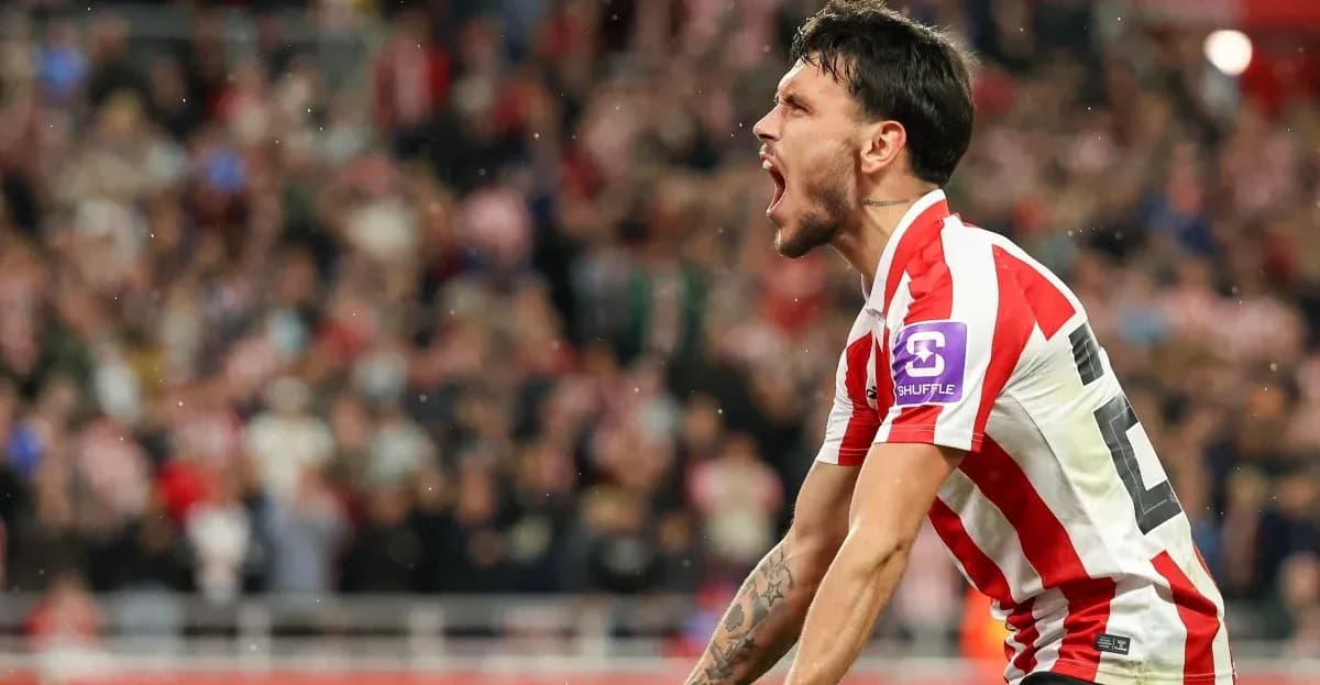 Player celebrating a goal in front of fans