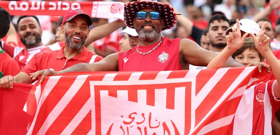 Fans celebrating with a flag at the stadium
