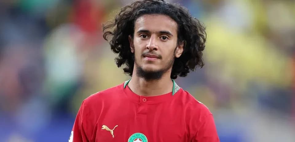Player in red jersey during match warm-up