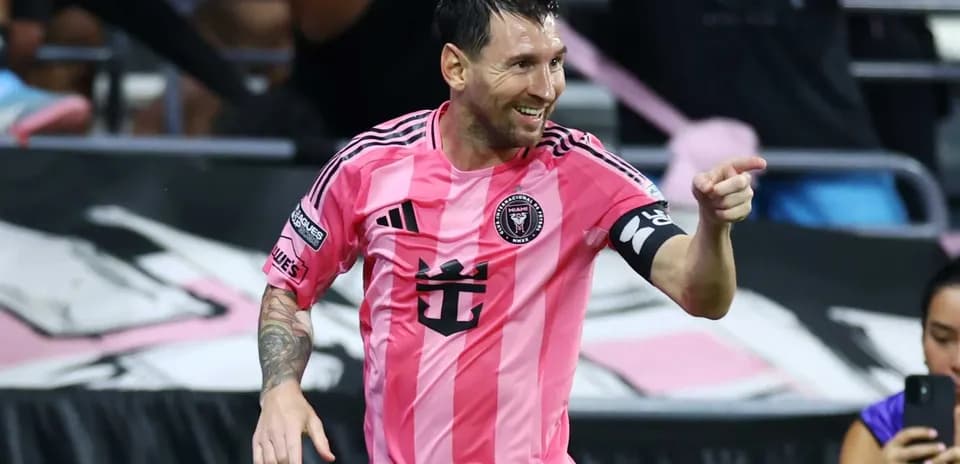 Player celebrating a goal in pink jersey