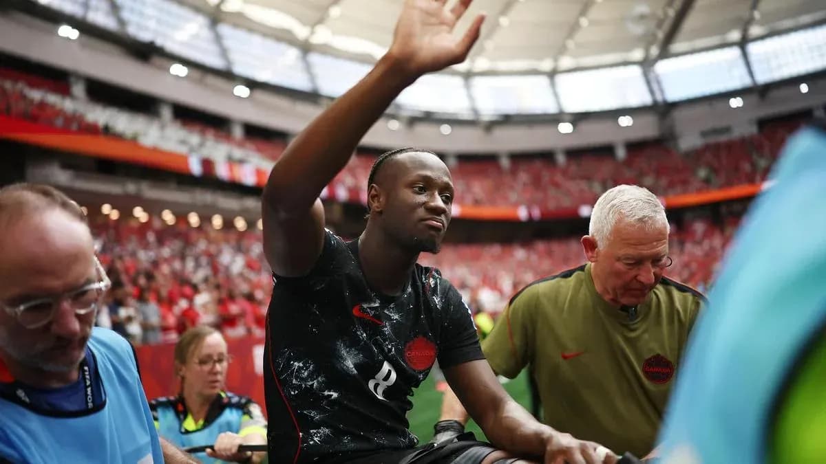 Player waving while being assisted off the field