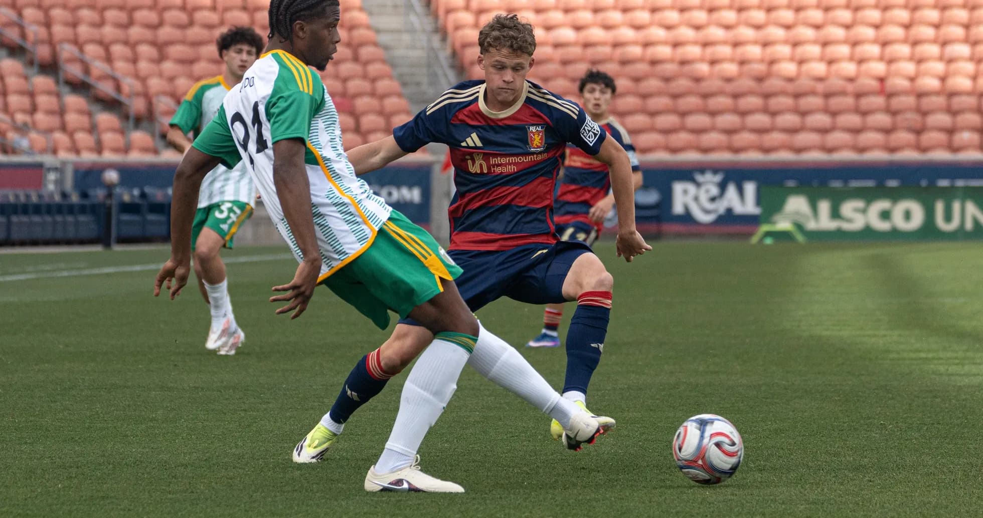 Player tackles opponent during MLS Next Pro match