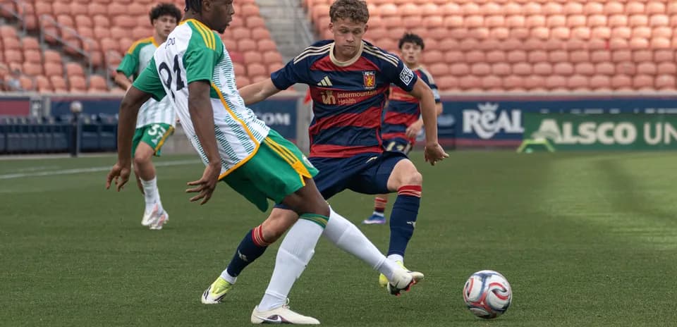 Player tackles opponent during MLS Next Pro match