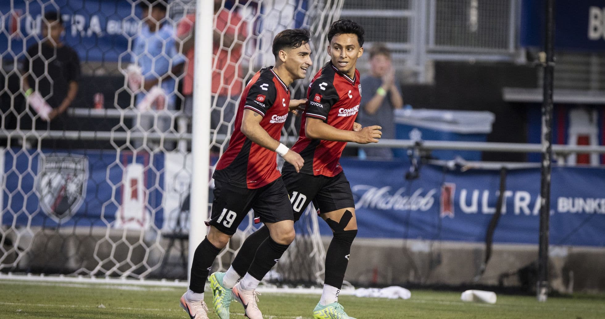 Players celebrating a goal during USL Championship match