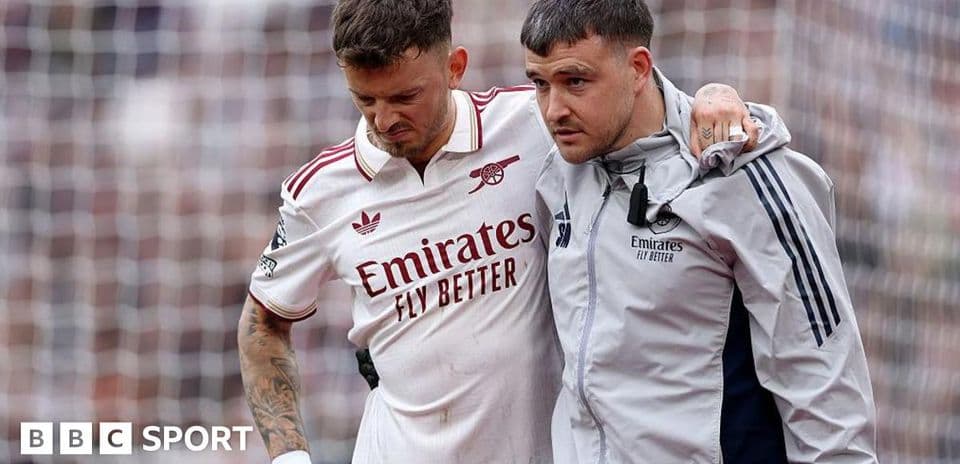 Player receiving assistance from medical staff on field