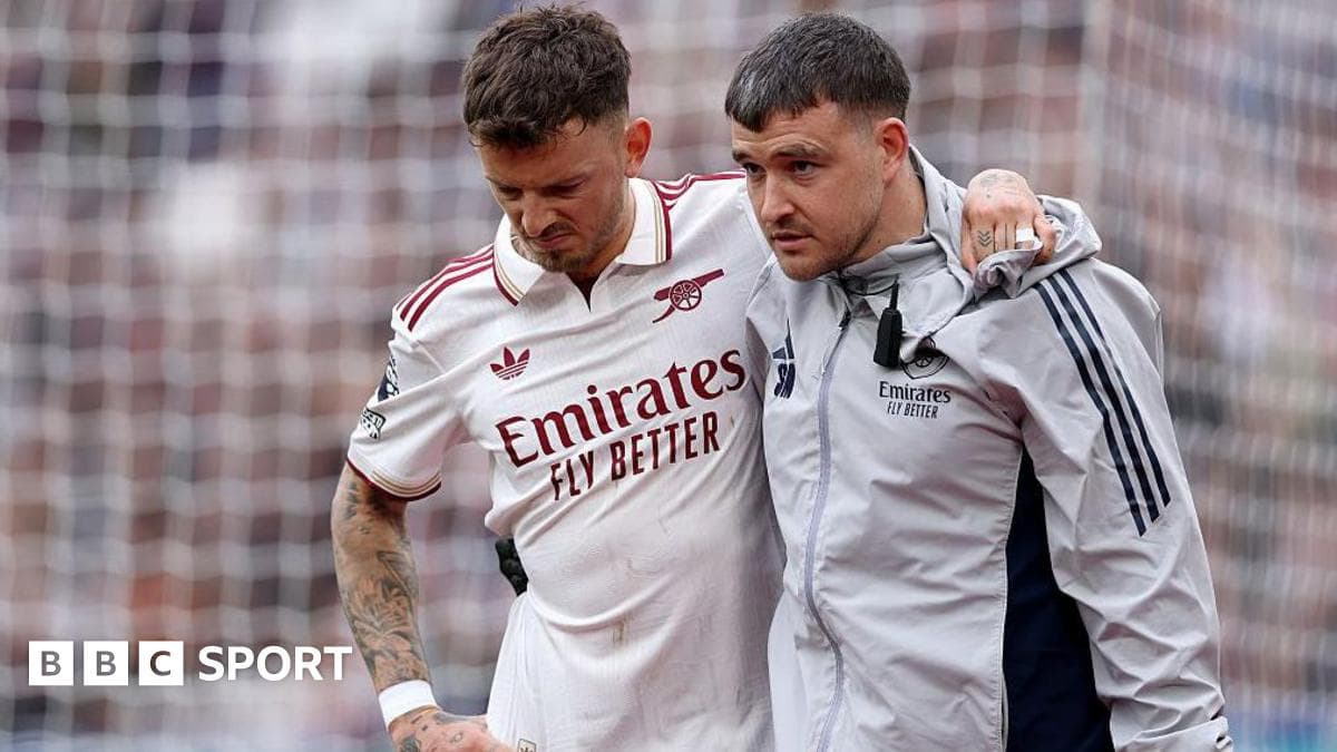 Player receiving assistance from medical staff on field