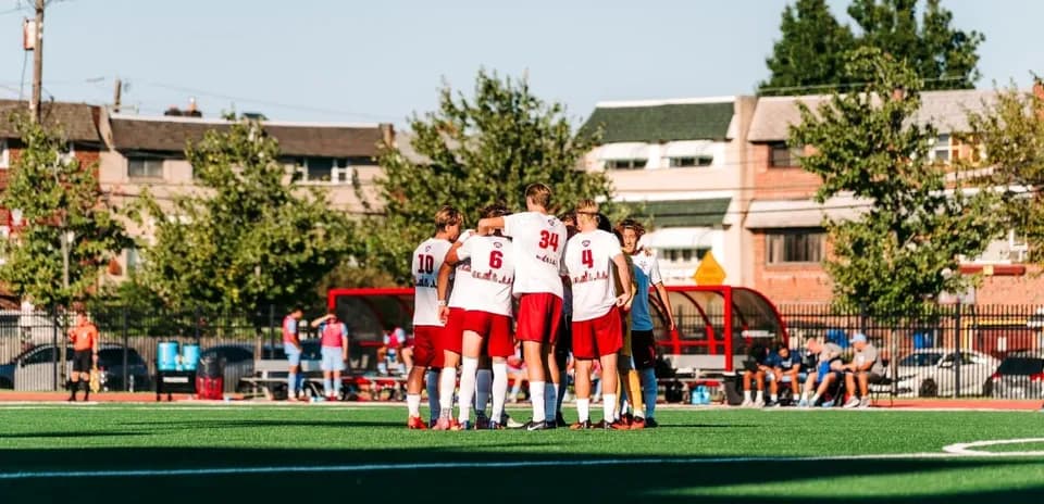 Team huddled together on soccer field before game