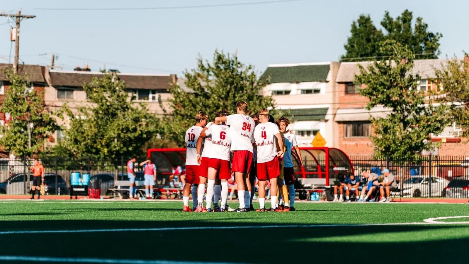 Team huddled together on soccer field before game