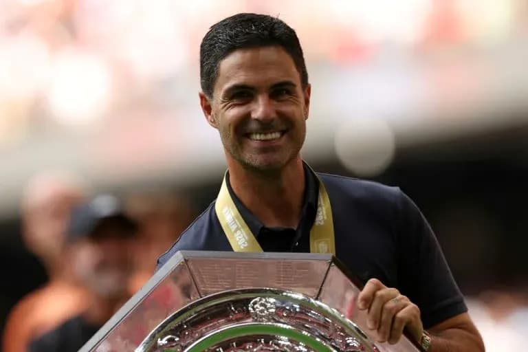 Coach holding trophy during celebratory event