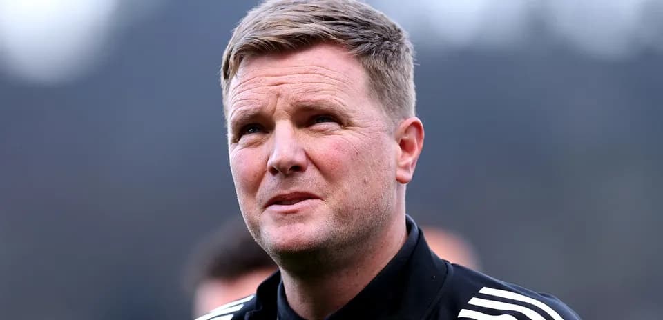 Football manager looking on during training session