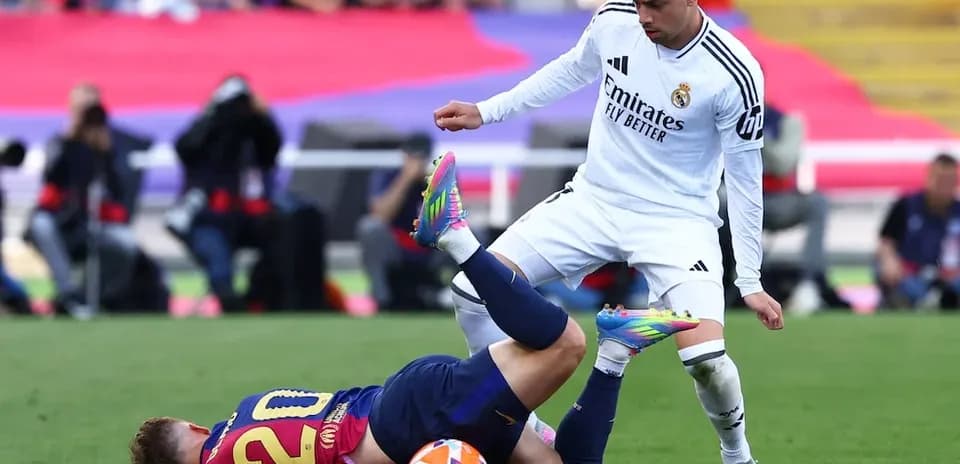Barcelona player tackled by Real Madrid opponent