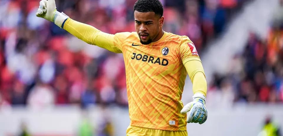 Goalkeeper in yellow jersey signaling during match