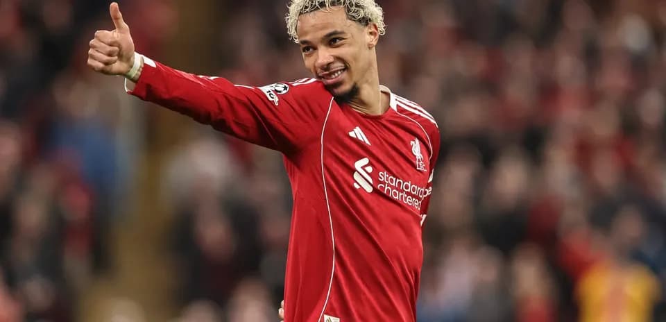 Player celebrating with thumbs up in Liverpool kit