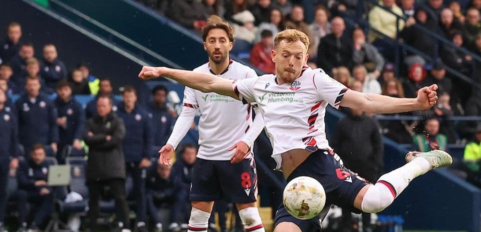 Player kicking the ball during a football match