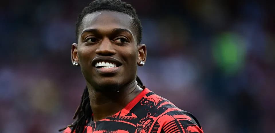 Player smiling while wearing a red patterned jersey