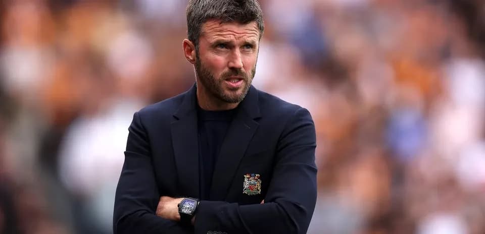 Coach observing the match with arms crossed