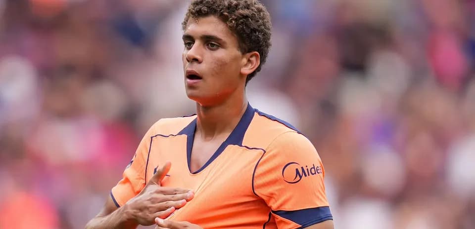 Player in orange jersey during match preparation