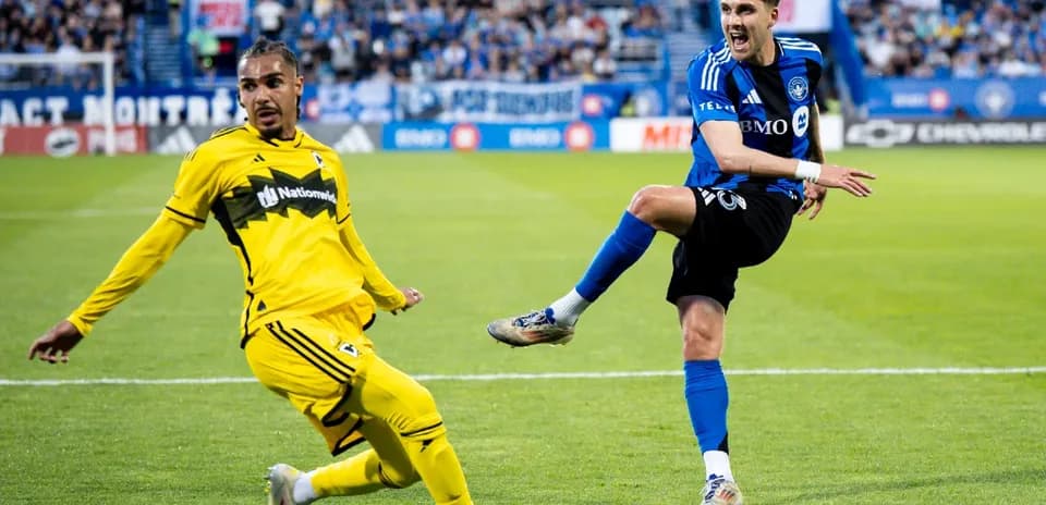 Columbus Crew player defending against CF Montreal