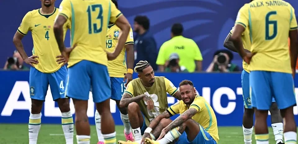 Brazil players surrounding injured teammate on field