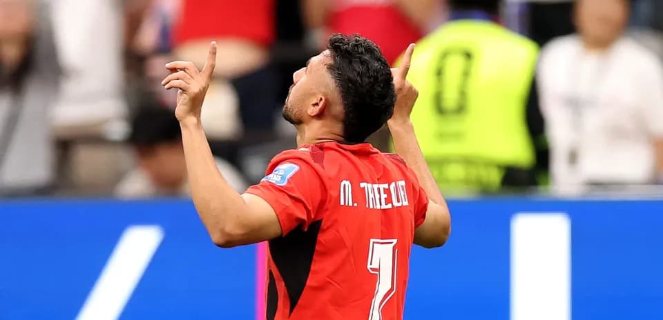 Player celebrating a goal with arms raised