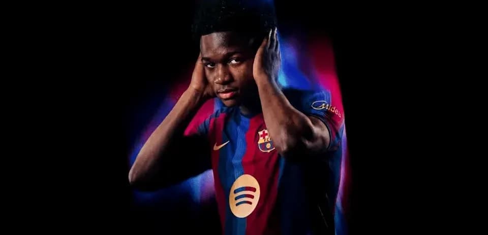 Player posing in Barcelona jersey with vibrant background