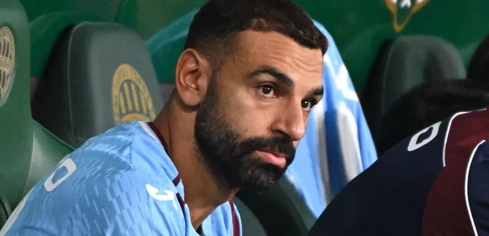 Player seated on bench during match