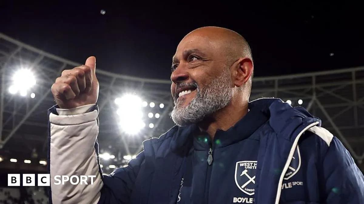Manager celebrating with thumbs up at stadium