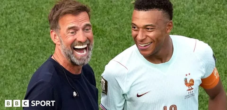 Two men smiling on the football field
