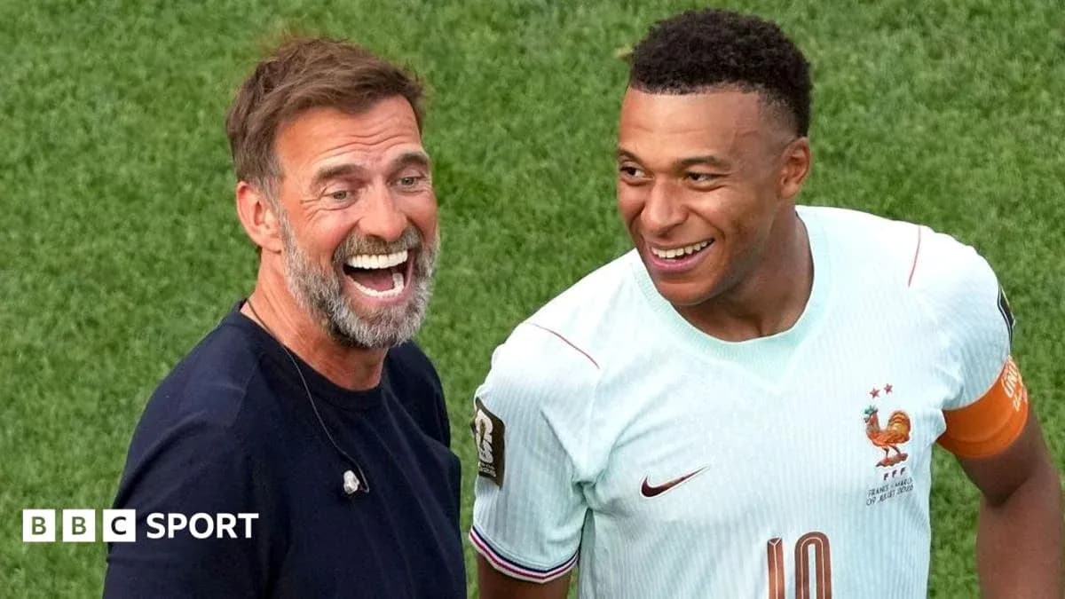 Two men smiling on the football field