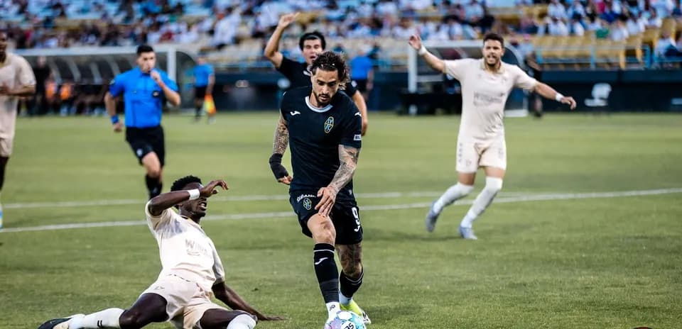 Las Vegas Lights player dribbling past FC Tulsa opponent