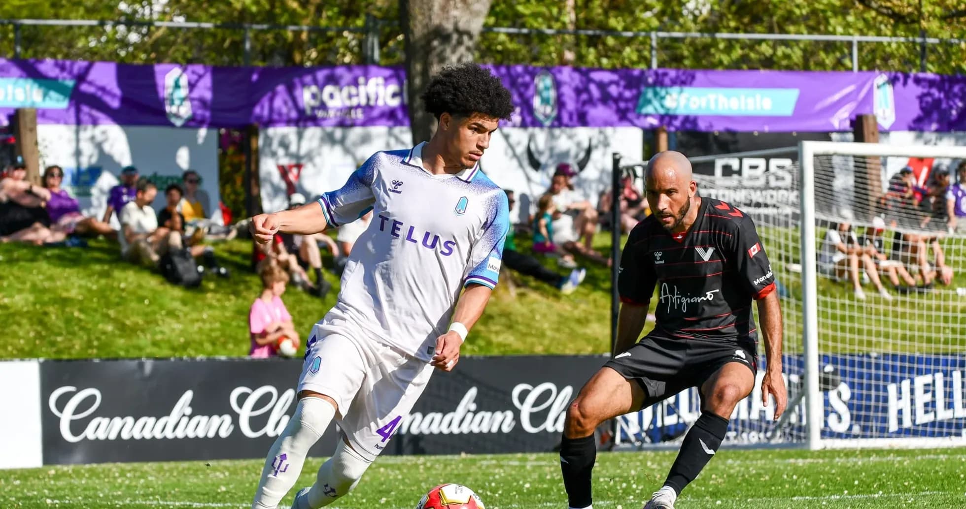 Pacific FC player dribbling past Vancouver FC opponent
