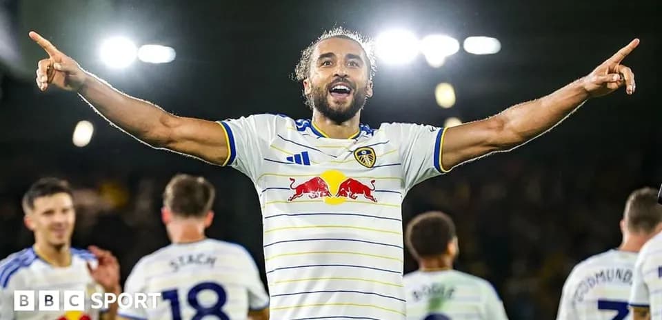 Player celebrating with arms raised after scoring