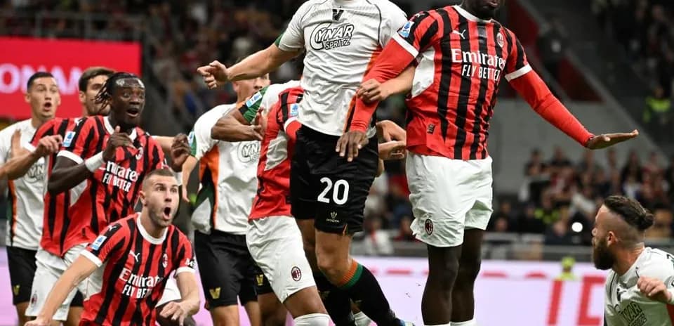 Players competing for a header during match