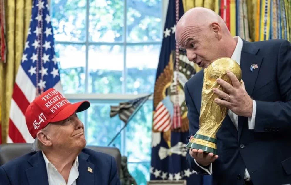 Person holding FIFA World Cup trophy in office