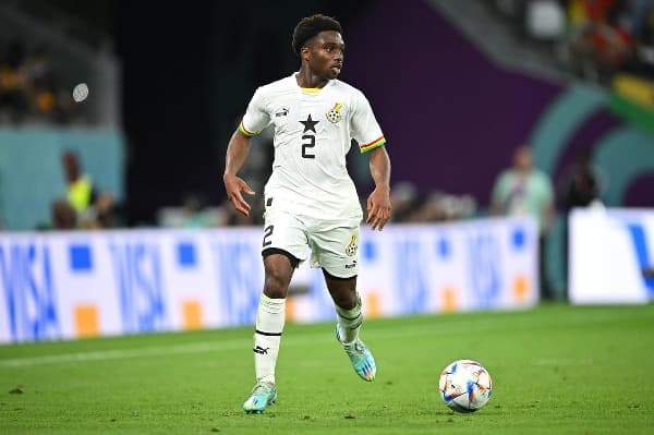 Ghana player dribbling ball during match