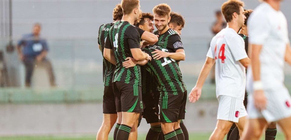 Players celebrating a goal during match