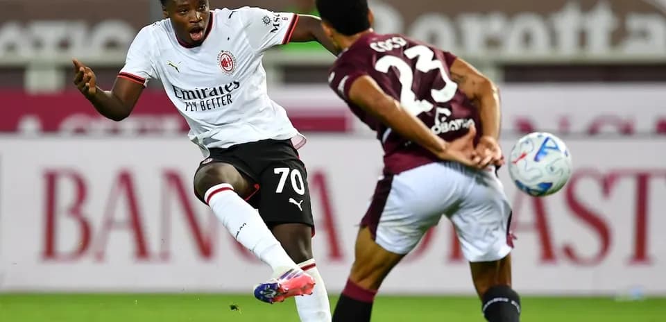 Player from AC Milan taking a shot on goal