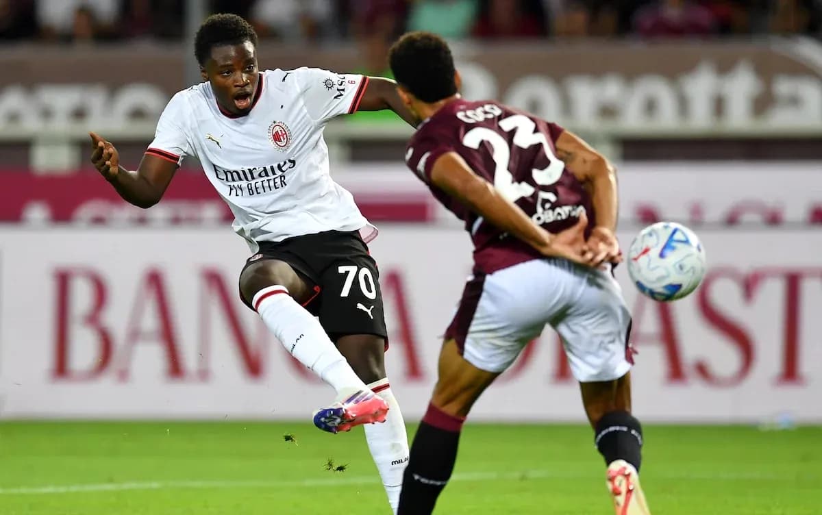 Player from AC Milan taking a shot on goal