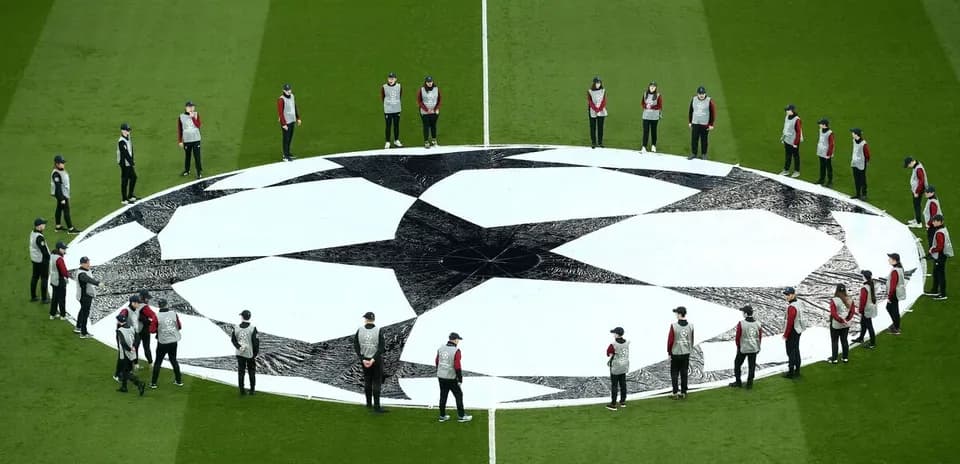 Ground staff preparing UEFA Champions League logo on field