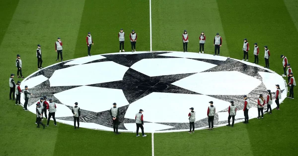 Ground staff preparing UEFA Champions League logo on field