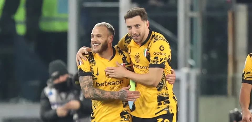 Two players celebrating a goal on the field