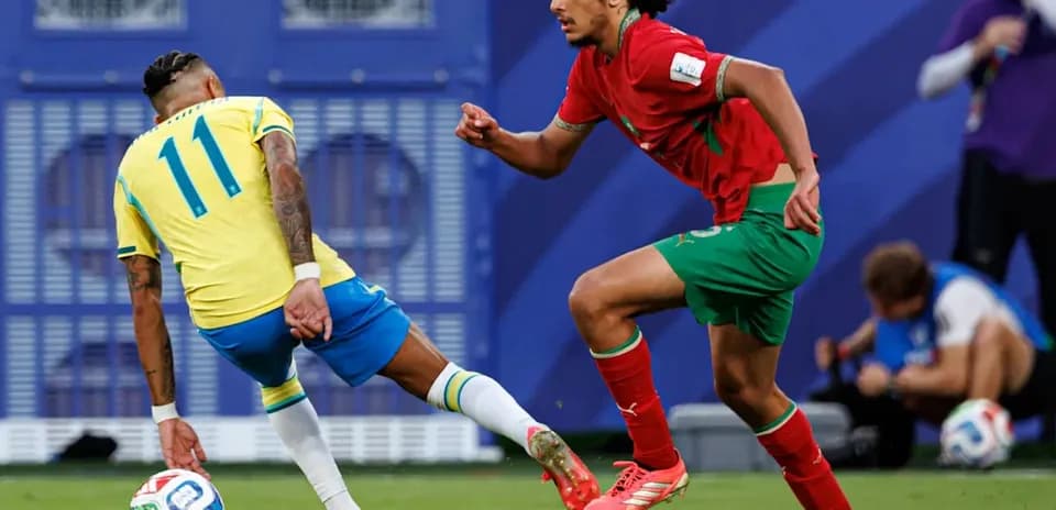 Brazilian player dribbling past Moroccan defender during match