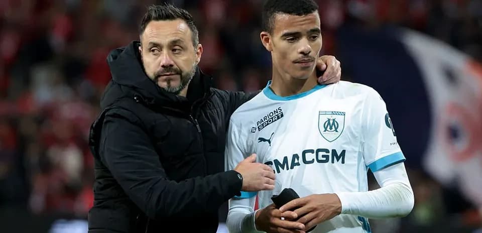 Coach with player after match on the field