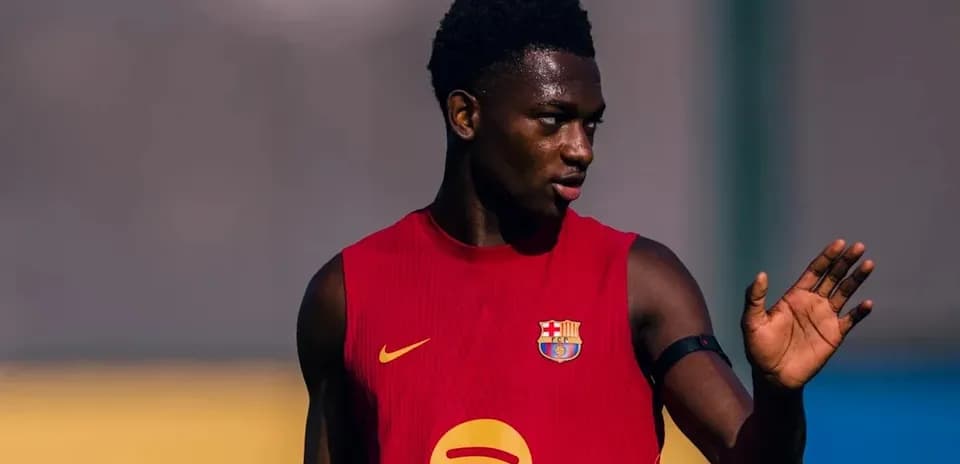 Player in red jersey gesturing during training session
