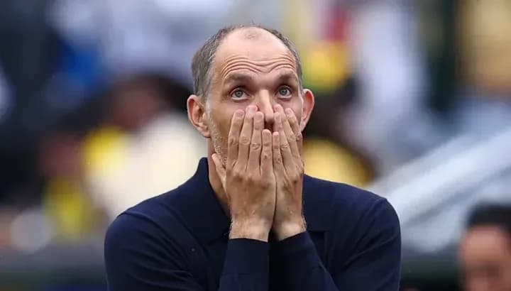 Coach with hands on face during match