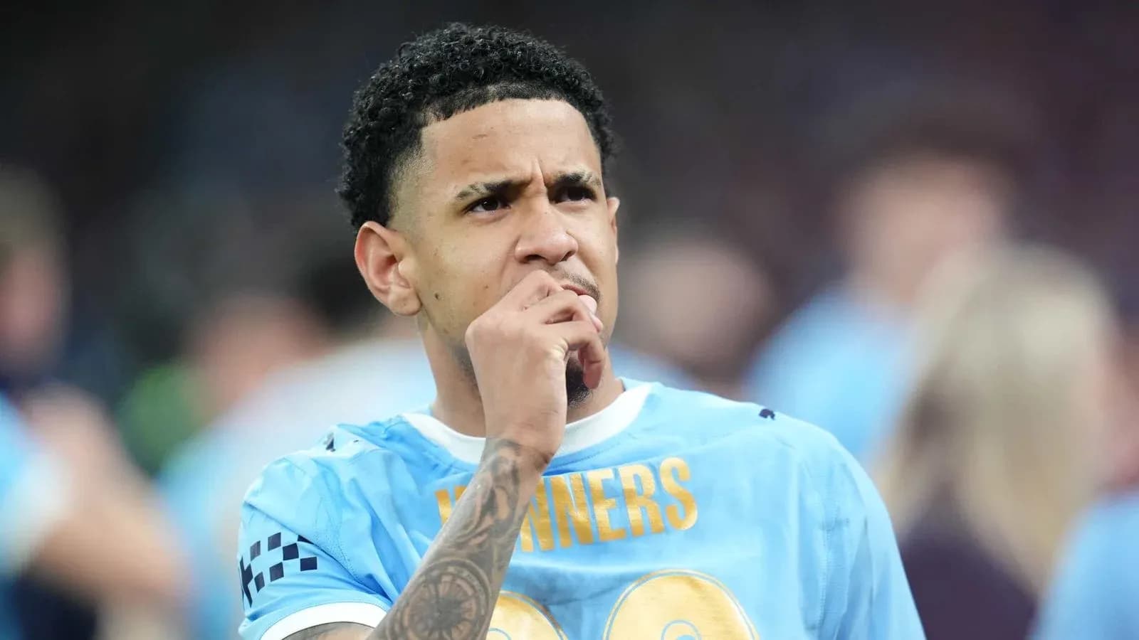 Player in blue jersey deep in thought