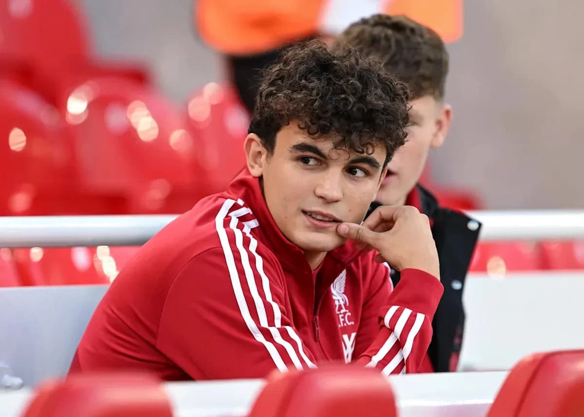 Player in Liverpool FC training kit on bench