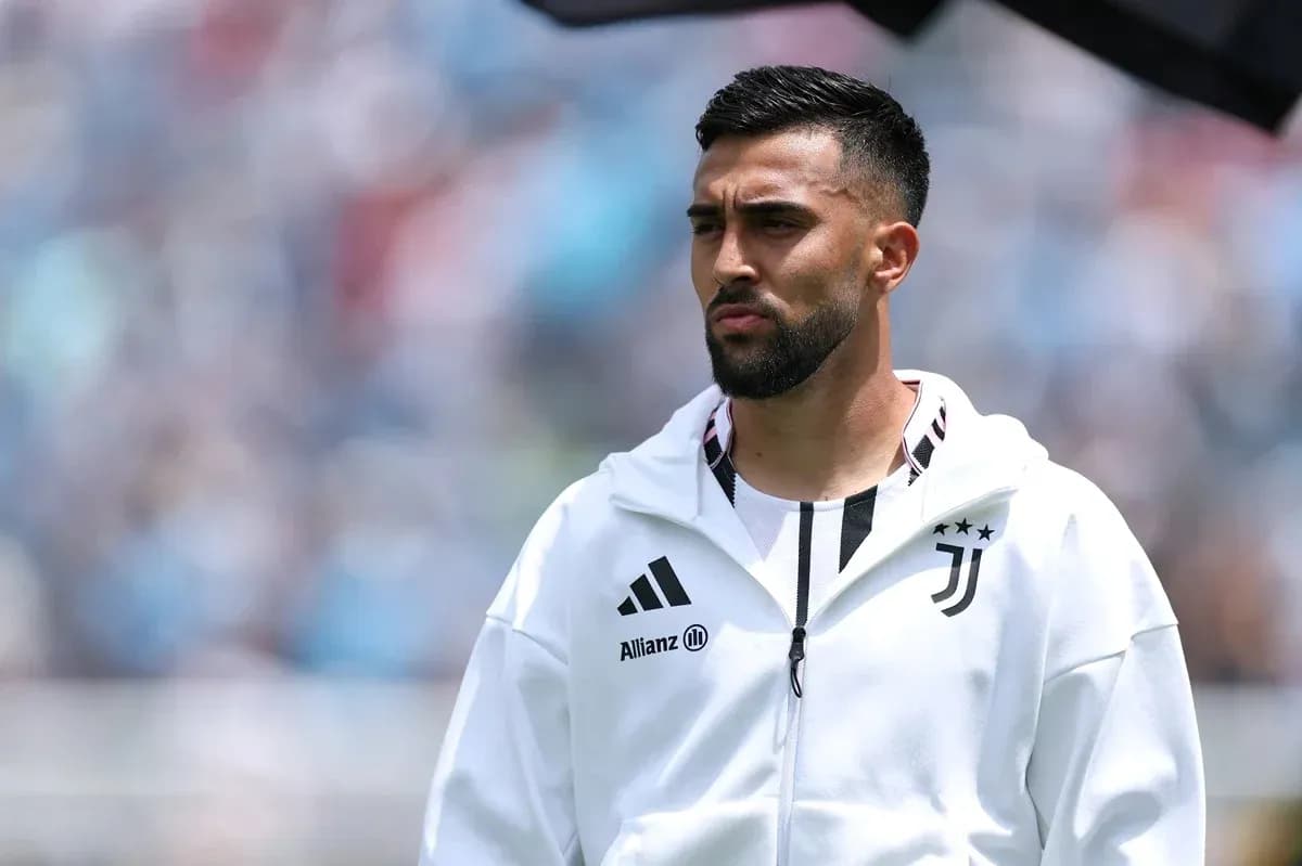 Player in Juventus hoodie on the sidelines