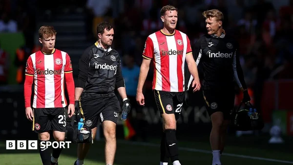 Brentford players and staff walking off the pitch Brentford players and staff walking off the pitch
