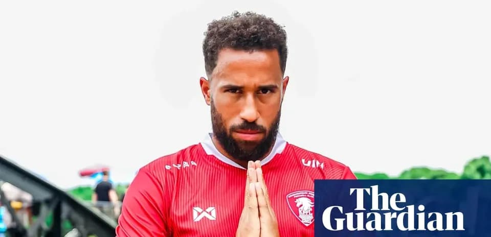 Player in red jersey with hands in prayer position
